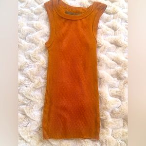 Orange sleeveless tank.